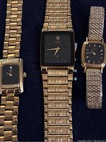 Photo showing three vintage gold-tone wristwatches with two Citizen and one Seiko brands, highlighted diamond on single Citizen watch.
