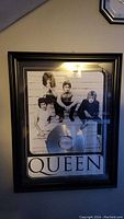 Framed wall art photo of Queen with silver record plate below, wall mounted.
