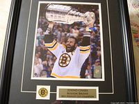 Frontal view of the framed photo showing Zdeno Chara holding the Stanley Cup trophy, with plaque and Bruins logo.