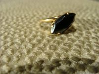 Side-angle view showing marquise-shaped hematite stone and prong setting