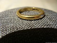 Ring angled on grey fabric, showing full band profile