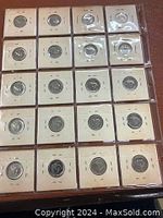 Overview photo showing a sheet of 20 1967 Canadian Centennial nickels each mounted separately in protective holders on a flat surface.