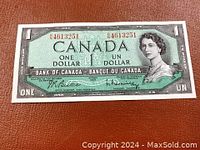 Front of 1954 Canadian one dollar banknote featuring Queen Elizabeth II, with serial number and bilingual text.