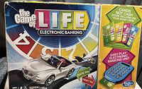 Photo of box front showing The Game of Life Electronic Banking Edition with image of convertible car and banking unit