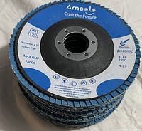 Stack of blue Amoole Zirconio flap grinding sanding discs labeled 4.5 inch diameter, 7/8 inch arbor, grit 120