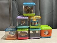 Eight Peekaboo stacking blocks arranged in pyramid shape showing various colors and items inside blocks