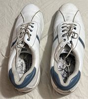 Top view of white ladies orthopaedic sneakers with blue accents and laces, showing the overall condition and design.