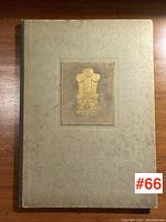 Front cover view showing gold embossed emblem and overall condition.