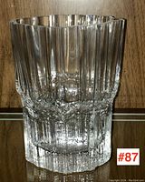 Front view of clear glass vase showing vertical ribs and textured middle section, highlighting material and design.
