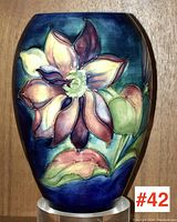 Front view showing large central flower in relief on deep blue background