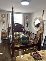 Full view of assembled four poster bed frame in room