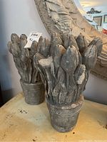 Both statues side by side on table with decorative mirror behind