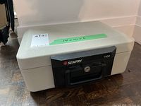 Beige Sentry 1100 safe showing front and top with measurement label (14x10x6 inches)