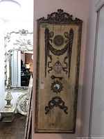 Full view of the tall wood wall hanging showing overall size, carving, and mirror features.