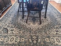 View of full rug under dining table showing overall design and size