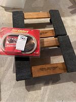 Haul Master movers dolly top view with black padding and Super Sliders furniture sliders set in packaging on top