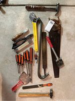 Overview of the collection showing the saw, adjustable wrench, files, screwdrivers, chisels, hammer, putty knives, hand drill, and ruler.