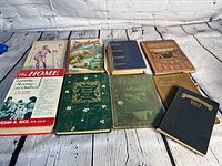Overview of all nine books in lot, showing front covers and general condition.