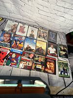 Overview of 17 new DVDs laid out on a flat surface with white brick background. Titles visible include classics, dramas, and action films.