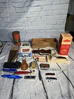 Full wide view of vintage collectibles laid on floor with white brick wall background