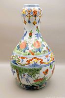 Front view of the double gourd shaped vase with colorful floral and bird decorations.