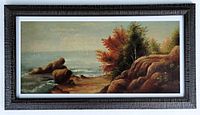 Full view of the oil on canvas painting in new dark textured frame with white mat and glass, showing coastal landscape with rocks and trees in autumn colors.