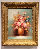 Frontal view of the oil painting in an ornate gold wood frame against a white wall