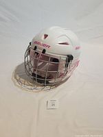 White Bauer youth hockey helmet with attached metal face cage and chin strap, shown from front angle.