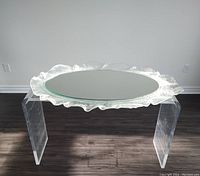 Full view of round mirror on acrylic display stand showing overall design