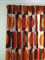 Left panel hanging full length on curtain rod showing geometric circle and square pattern