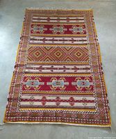 Overhead view of full rug laid flat on concrete floor