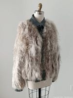 Front view of fur jacket on mannequin