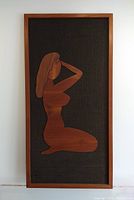 Full frontal view of teak silhouette wall art on white backdrop