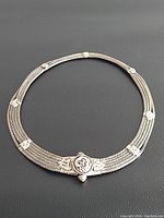 Full view of the vintage tribal silver necklace showing twisted wire strands and central decorative medallion.