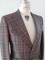 Front side view of gray and red plaid wool blazer on a size 40 men's dress form showing button closure and lapels.