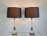 Both lamps lit, front view on clear surface