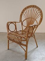 Full front-side view of the bamboo lounge chair showing the fan-back design and circular arm details.