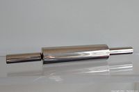 Photo of stainless steel commercial rolling pin on white surface, showing full length and smooth polished finish.