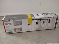 Boxed Canvas 4-light farmhouse industrial style chandelier, showing brand and style on packaging.