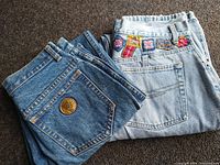 Close-up of back pockets of both jeans, showing Puma logo and patches on Bugle Boy jeans.