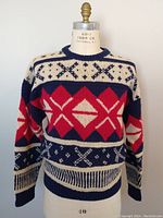 Front full view of vintage 1980s GANT hand knit ski sweater featuring red, navy blue, and off-white geometric patterns.