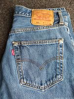 Close-up image of back pocket with Levi's red tab and leather size patch showing size 31W 32L.