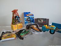 Full lot with Looney Tunes figurine, Sonic Happy Meal toys, Hot Wheels car in packaging, steamroller toy, and Super Nintendo game cartridge.