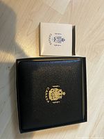 Closed white envelope marked ‘Canada 1967’ and black presentation case with gold-foil crest