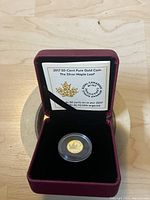 2017 Canadian 50-cent pure gold coin in capsule in burgundy presentation box with certificate visible