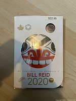 Front of the packaging showing the Bill Reid 2020 artwork with a window displaying the $2 coin.