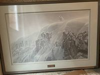 Full view of framed print depicting snowy cliff landscape with white wolf at top