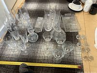 Photo showing assorted lead crystal glasses, decanter, and dishes