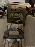 Five boxed Ulu knife chopping bowl sets arranged in a row, showing packaging fronts