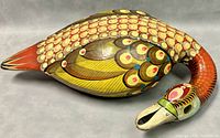 Top angle showing the colorful detailed hand painted feathers and head of the paper mache goose.